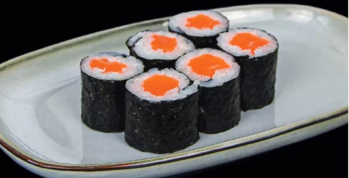 Six makis saumon sur une assiette en céramique